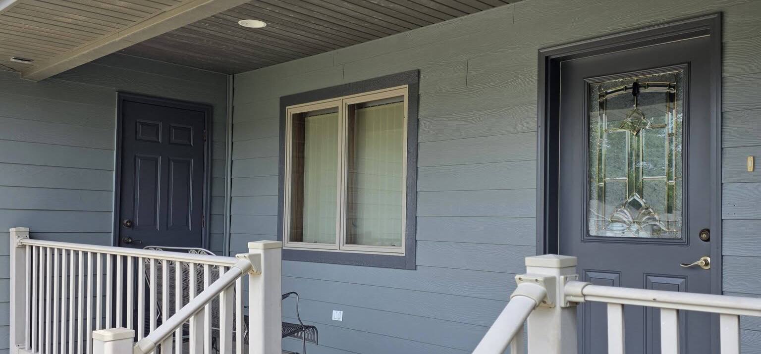covered front porch with siding and door repainted blue gray