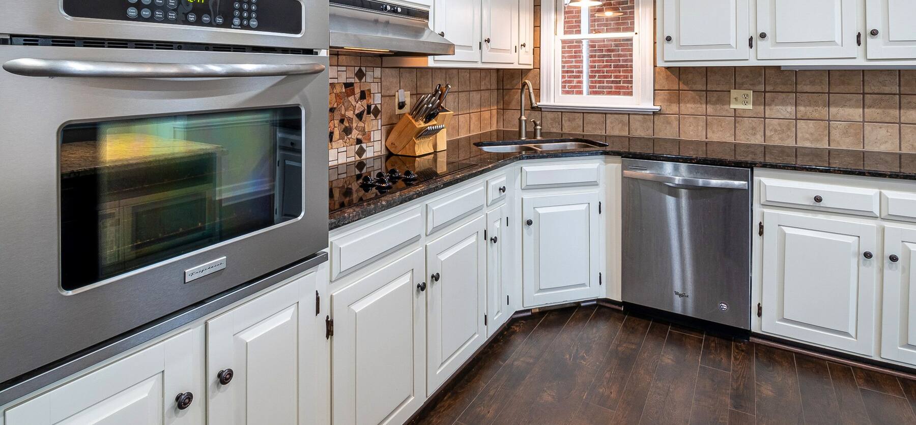 kitchen with white painted cabinets and stainless appliances