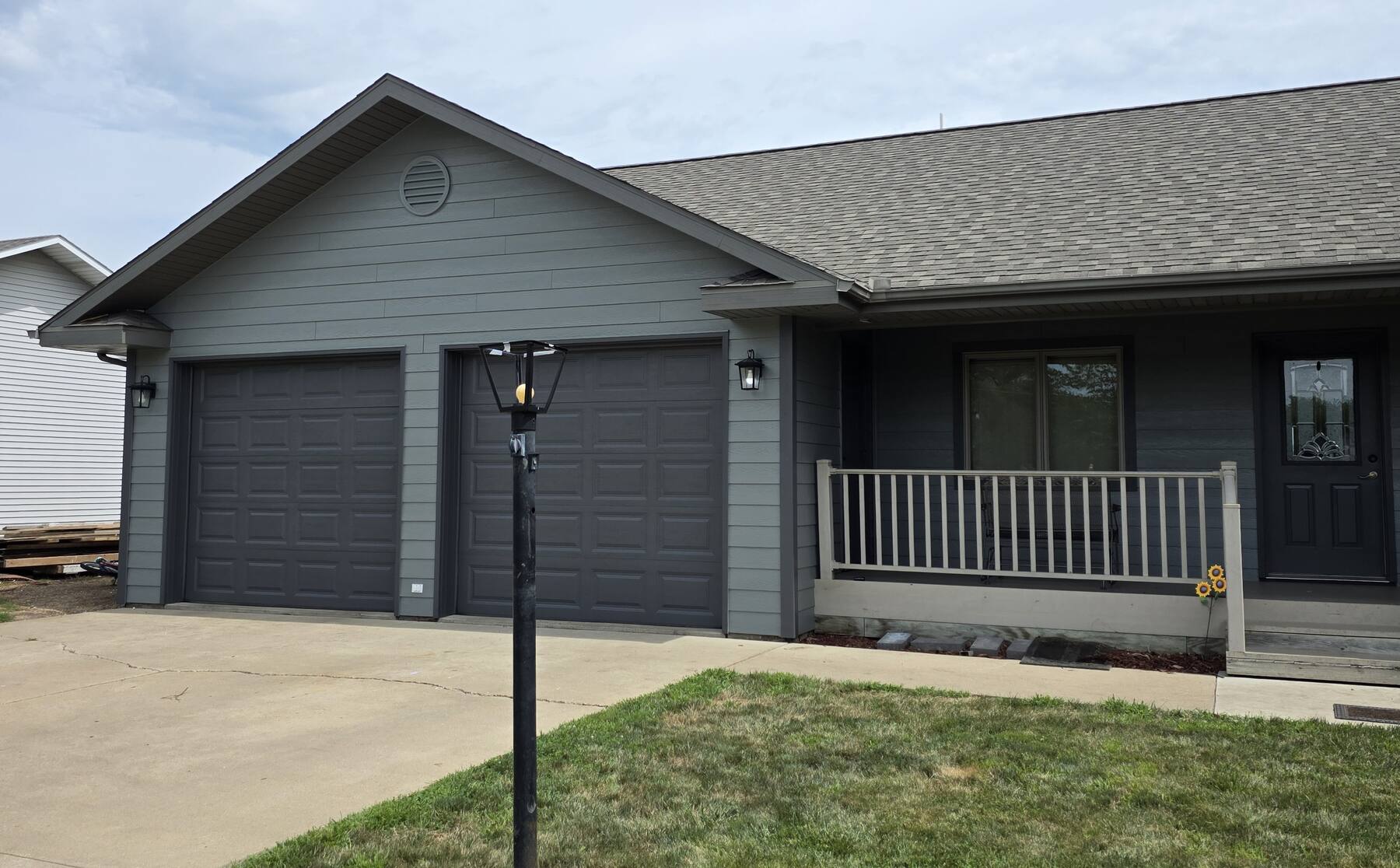 ranch house and attached garage repainted dark gray