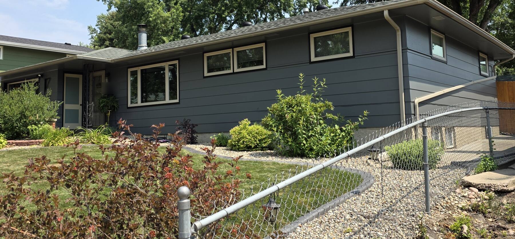 mid-century ranch house repainted dark slate