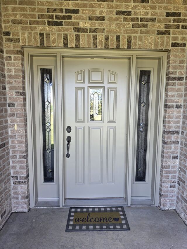 After: front entry door, sidelights and frame repainted from brown to a soft cream