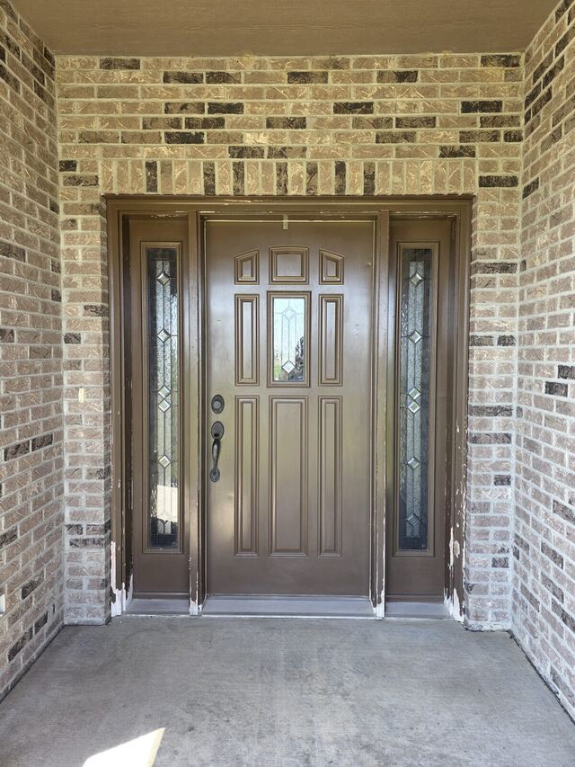 Before: front entry door, sidelights and frame repainted from brown to a soft cream