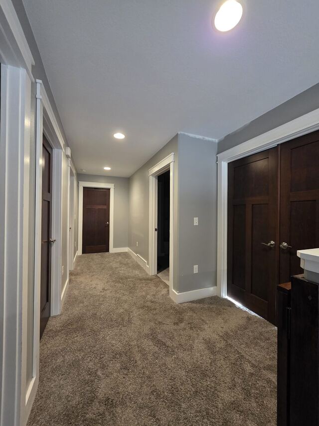 Before: hallway with dark stained doors, walls repainted a warm gray with crisp white trim