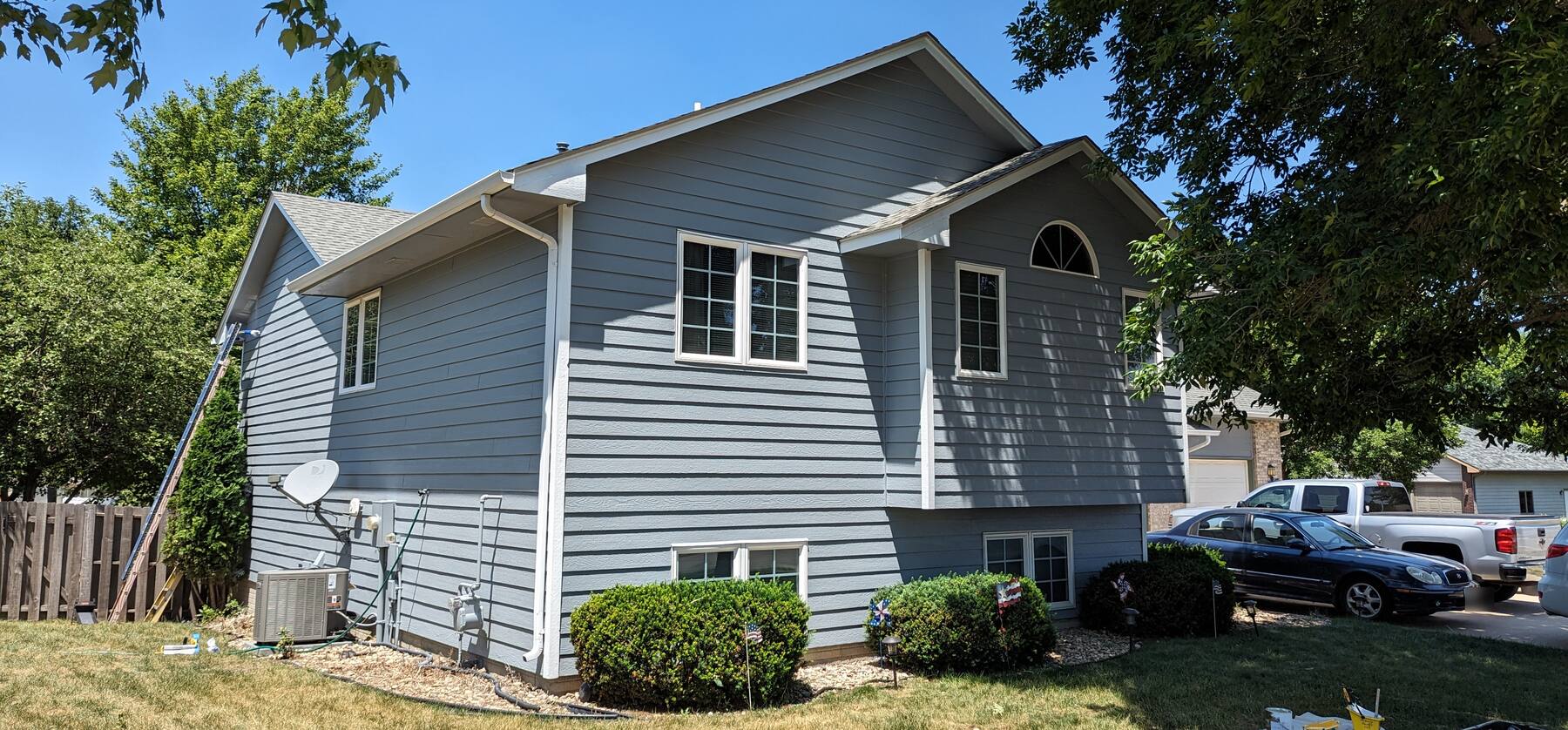 A recent McDugle Paints project: split level house repainted from green to blue gray with white trim