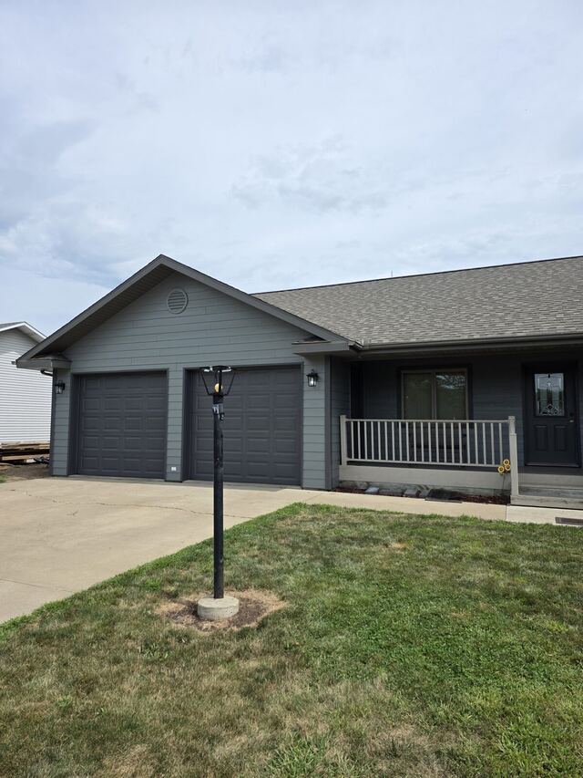 After: ranch house and attached two car garage repainted from cream to dark gray with matching garage doors