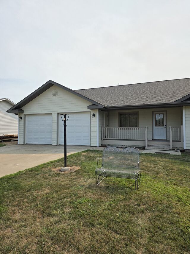 Before: ranch house and attached two car garage repainted from cream to dark gray with matching garage doors