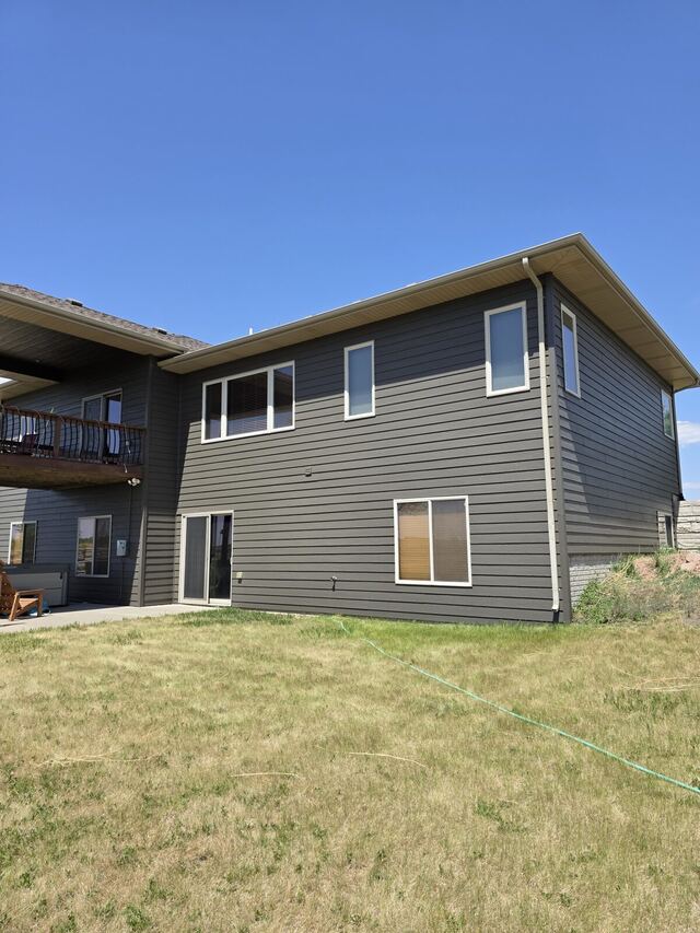 After: back of a two story house repainted from tan to charcoal gray